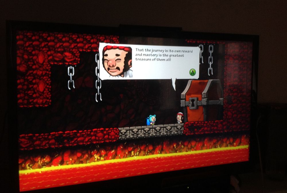 Photo of a TV screen showing the secret Hell ending of the videogame Spelunky. The screen has the character Yang giving a quote: "That the journey is its own reward and mastery is the greatest treasure of them all!"