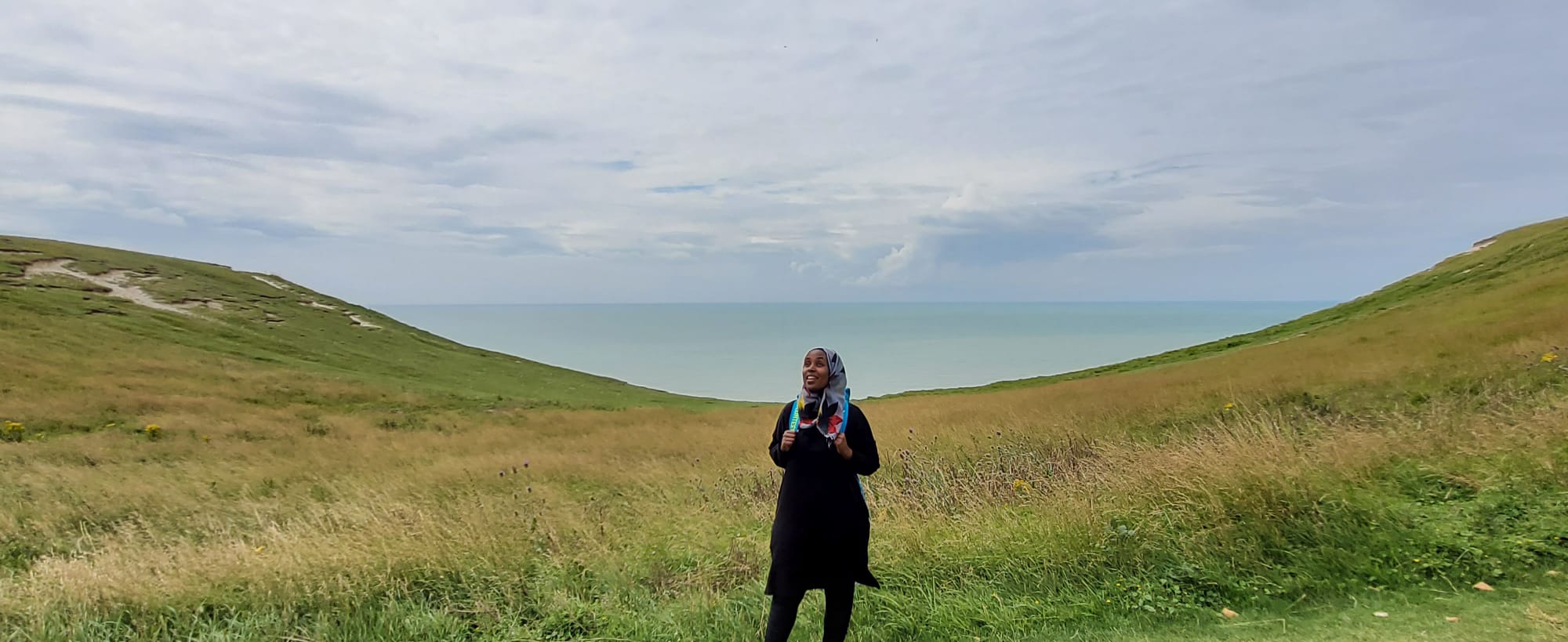 Halima pictured in the centre of the image on a hike of The Seven Sisters, a series of chalk sea cliffs on the English Channel coast.